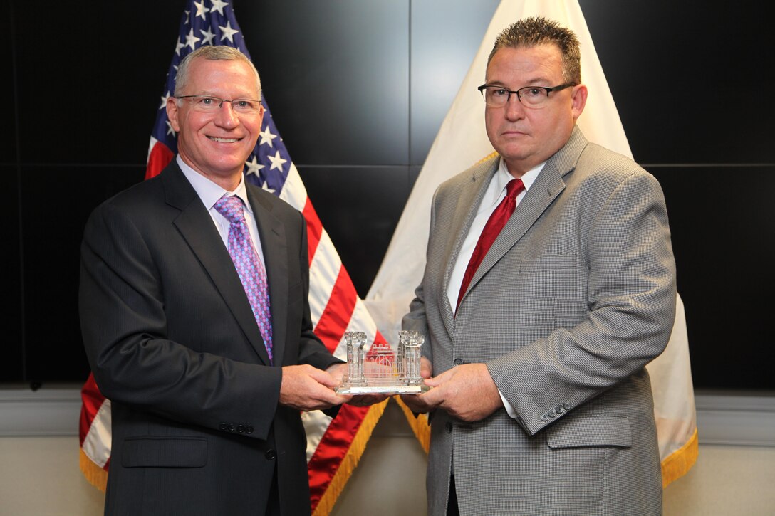 Michael C. Orr, Deputy Chief, Omaha District Contracting receives the Crystal Rock the Castle award from Mr. Stuart Hazlett, Directorate of Contracting  at USACE Headquarters in Washington, D. C. (Photo courtesy of U. S. Army Corps of Engineers)