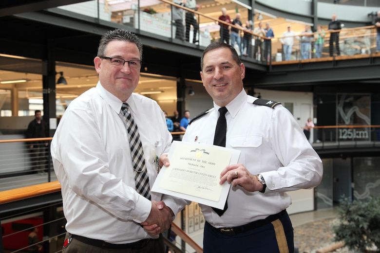 Colonel John G. Buck, Commander, Seattle District presents a Commanders Award to Michael C. Orr, Deputy Chief, Omaha District Contracting following his temporary duty to the Seattle District office in 2014. (Photo courtesy of Seattle District Corps of Engineers) 