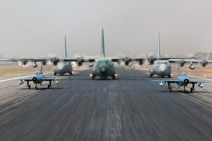 BAF BASE BANGABANDHU, Bangladesh (Jan. 28, 2015) - Two Bangladesh F-7BG Defenders, a BAF C-130B Hercules, and two U.S. Air Force C-130H Hercules aircraft prepare to take off during Exercise COPE SOUTH. The U.S. C-130H is assigned to the 374th Airlift Wing, Yokota Air base, Japan; the BAF F-7BGs are assigned to 5th Squadron and the BAF C-130B is assigned to 101st Special Flying Unit at BAF Base Bangabandhu. COPE SOUTH is a Pacific Air Forces-sponsored, bilateral tactical airlift exercise conducted in Bangladesh, with a focus on cooperative flight operations, day and night low-level navigation, tactical airdrop, and air-land missions as well as subject-matter expert exchanges in the fields of operations, maintenance and rigging disciplines. 
