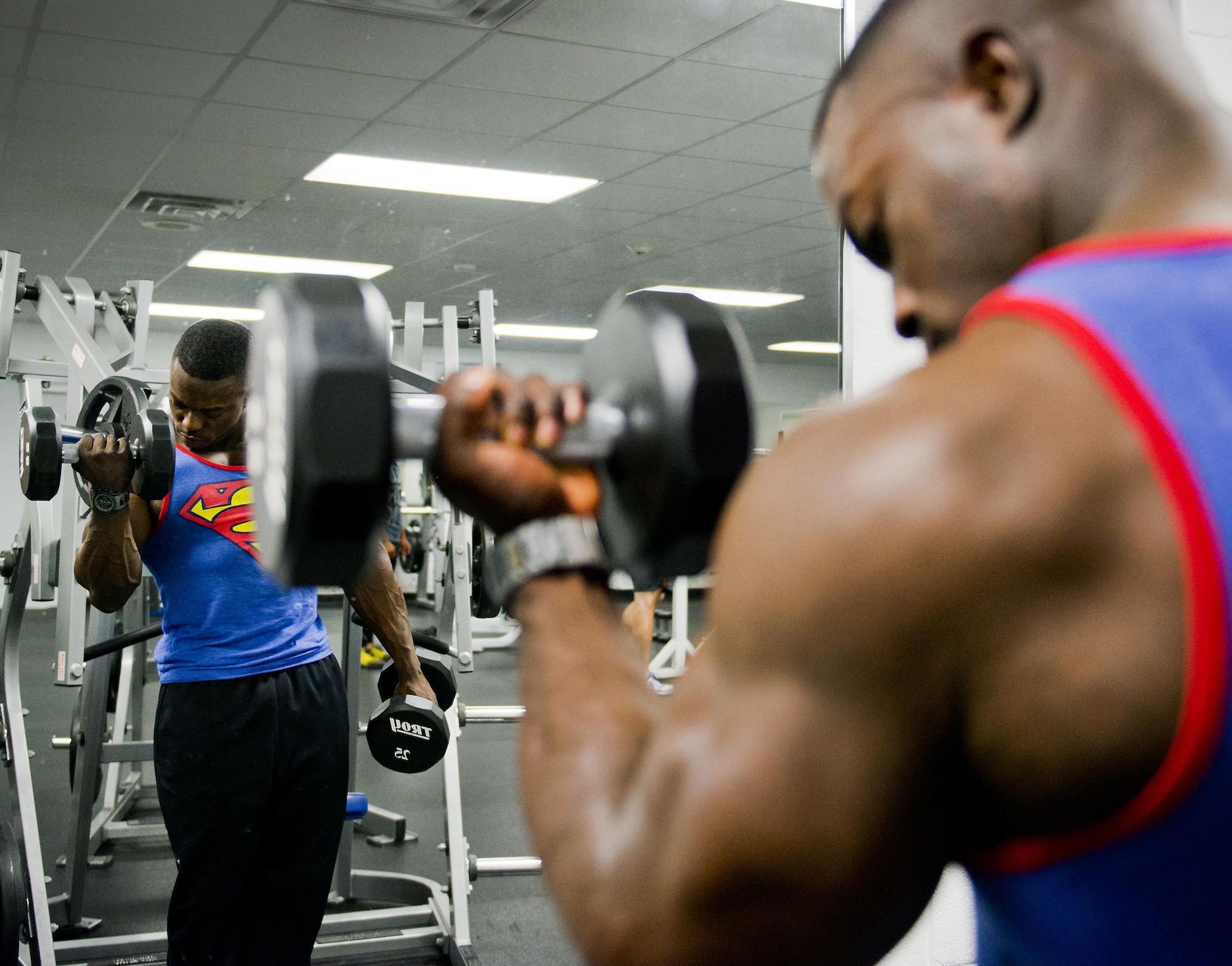 Senior Airman Terrence Ruffin  lifts 25-pound dumbbells at the fitness center on Eglin Air Force Base, Fla. In November, he became the youngest professional bodybuilder on the circuit at age 21. Ruffin is an avionics Airman with the 16th Electronic Warfare Squadron. (U.S. Air Force photo/Samuel King Jr.)