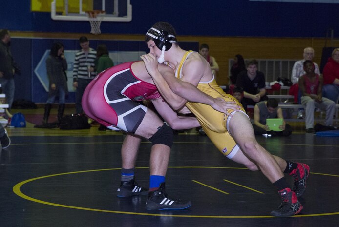 Wrestlers from Matthew C. Perry High School and the E. J. King High School in United States Fleet Activities Sasebo, Japan, face-off during at tournament, Jan. 31, 2015, inside IronWorks Gym aboard Marine Corps Air Station Iwakuni. In this tournament an individual from each weight class receives an award, not a team as a whole.