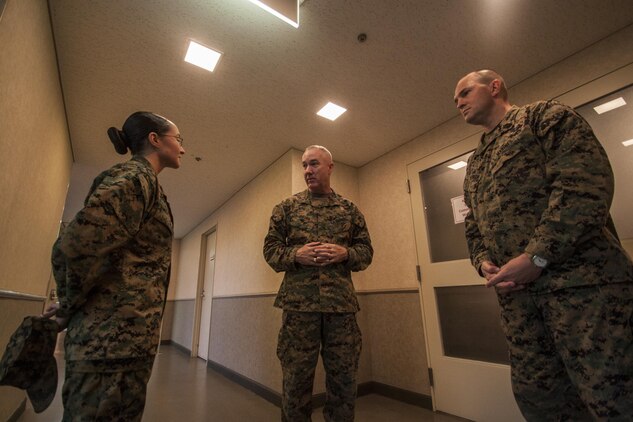 Cpl. Guadalupe Campos, a broadcaster with American Forces Network, Marine Corps Air Station Iwakuni, Japan, talks with Maj. Gen. Charles Hudson, commanding general of Marine Corps Installations Pacific, and Sgt. Maj. Robert Williamson, MCIPAC sergeant major, while inside Club Iwakuni aboard MCAS Iwakuni, Jan 13, 2015. Campos was recognized as the 2014 MCIPAC Marine of the Year and will continue on to the 2014 Marine Corps Installations Command Marine of the Year board.