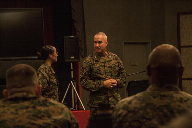 Maj. Gen. Charles Hudson, commanding general of Marine Corps Installations Pacific, talks to Cpl. Guadalupe Campos, a broadcaster with American Forces Network, Marine Corps Air Station Iwakuni, Japan, during the MCIPAC Commander’s Conference inside the Club Iwakuni ballroom, Jan 13, 2015. Campos was recognized as the 2014 MCIPAC Marine of the Year and will continue on to the 2014 Marine Corps Installations Command Marine of the Year board.