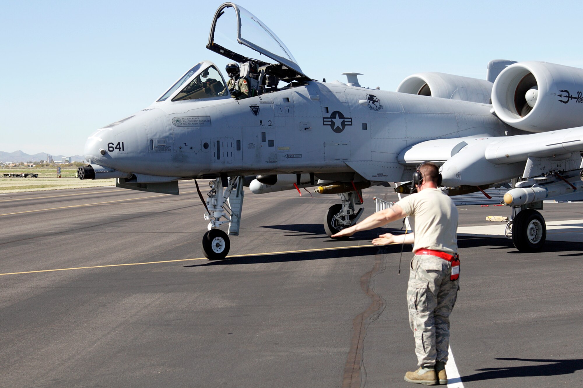 A crew chief from the 127th Maintenance Squadron marshals an A-10 Thunderbolt II for a training mission at Davis-Monthan Air Force Base, Ariz., Feb. 3, 2015. The aircraft is from the 107th Fighter Squadron, 127th Wing, Michigan Air National Guard and is home-stationed at Selfridge Air National Guard Base, Mich. (U.S. Air National Guard photo by Tech. Sgt. Dan Heaton)