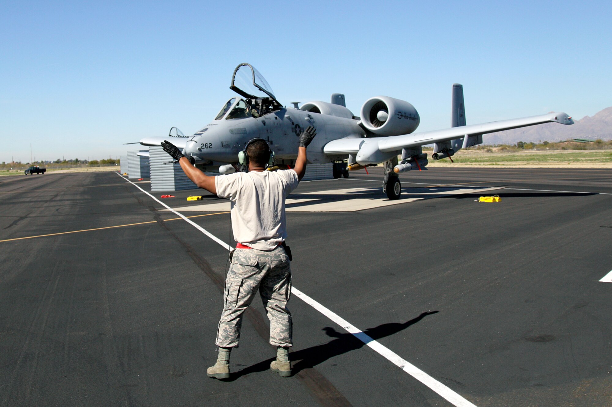 A crew chief from the 127th Maintenance Squadron marshals an A-10 Thunderbolt II for a training mission at Davis-Monthan Air Force Base, Ariz., Feb. 3, 2015. The aircraft is from the 107th Fighter Squadron, 127th Wing, Michigan Air National Guard and is home-stationed at Selfridge Air National Guard Base, Mich. (U.S. Air National Guard photo by Tech. Sgt. Dan Heaton)