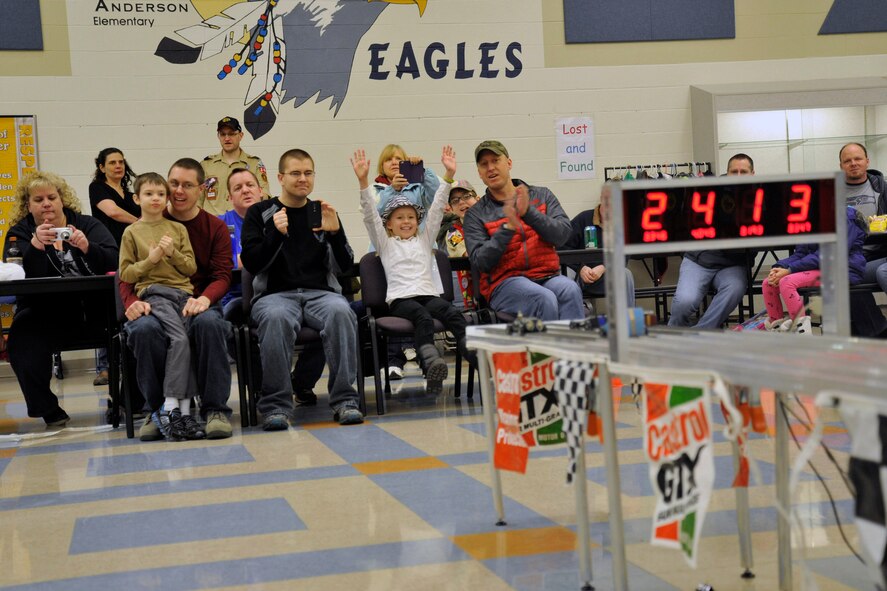 Competitors watch as their Pinewood Derby cars cross the finish line Jan. 31, 2015, at Fairchild Air Force Base, Wash. The Pinewood Derby not only put Cub Scout against Cub Scout, but also included siblings. Siblings raced against one another to see who built the fastest Pinewood Derby car. (U.S. Air Force photo/Airman 1st Class Nicolo J. Daniello) 