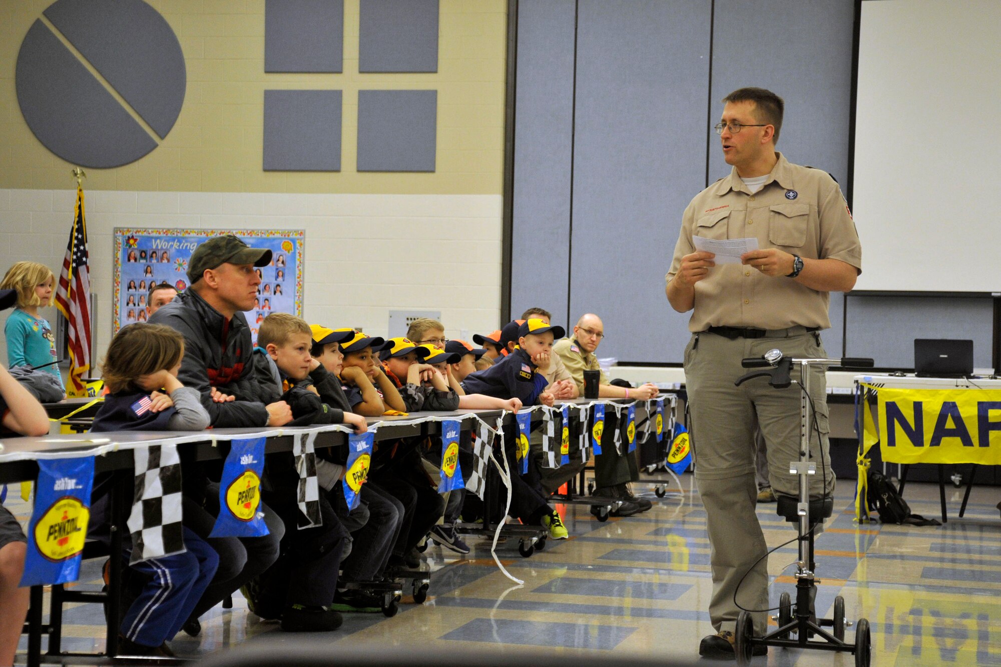 Senior Master Sgt. Lester Gaither, 92nd Maintenance Group superintendent and cub master for Pack 347, makes announcements to the Cub Scouts and families before the Pinewood Derby Jan. 31, 2015, at Fairchild Air Force Base, Wash. More than 20 people competed in the Pinewood Derby. (U.S. Air Force photo/Airman 1st Class Nicolo J. Daniello)