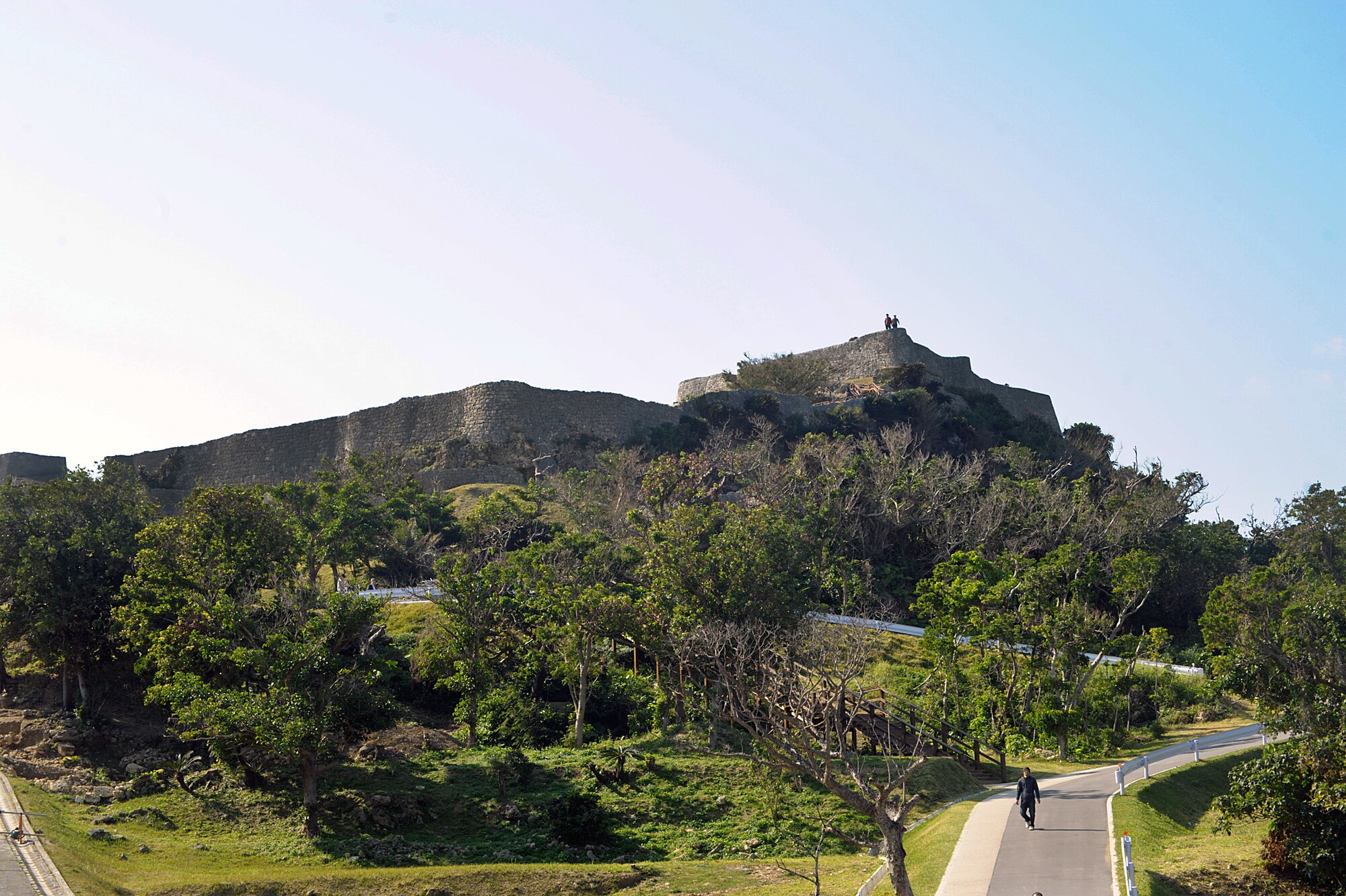 Tourists stand at the top of the Katsuren Castle ruins, about 300 feet above the coastline on Okinawa, Japan, on Jan. 25, 2015. The castle, which dates back to the 13th century, was added to the World Heritage List in 2000. (U.S. Air Force photo by Tim Flack)