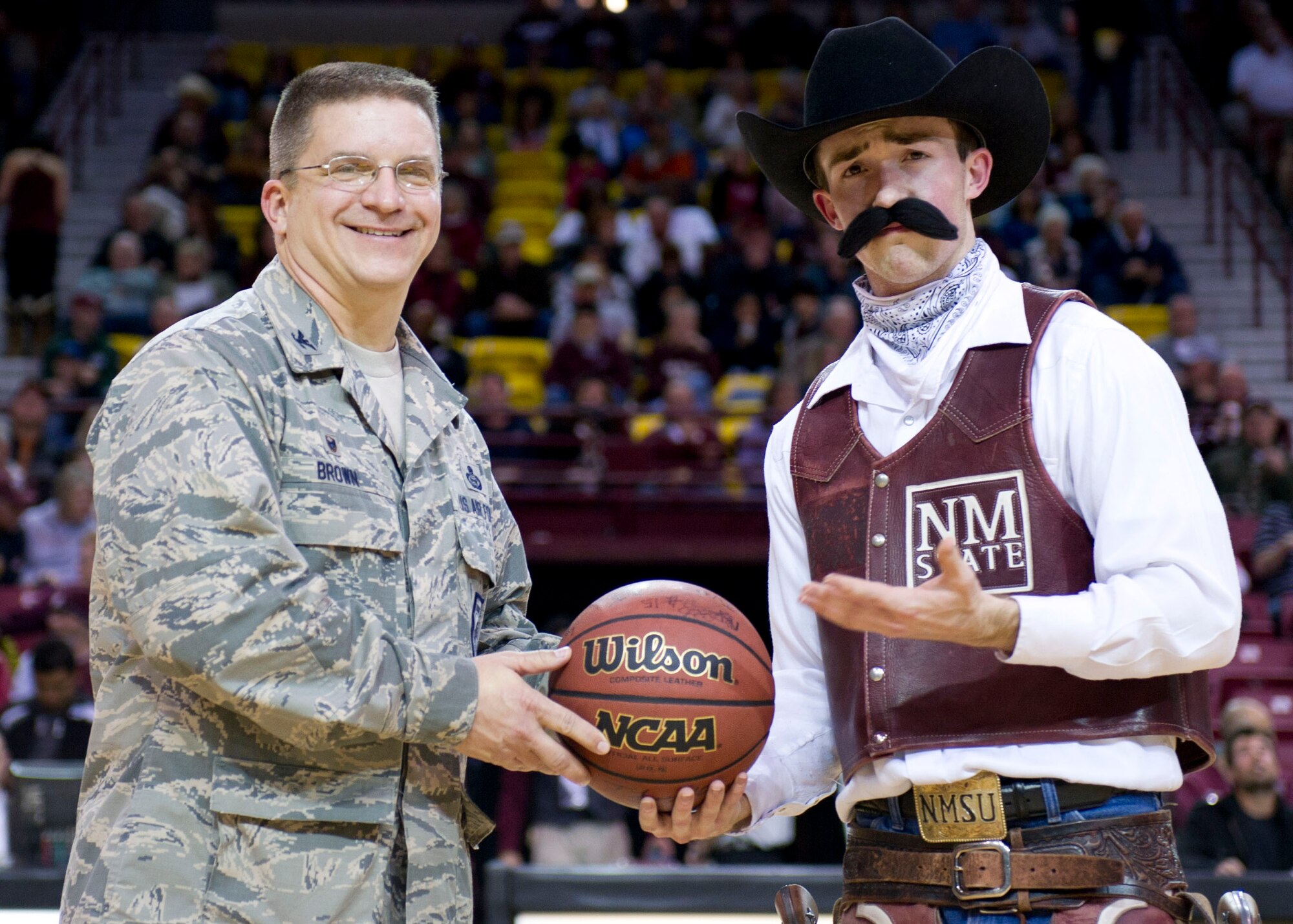 Col. Robert G. Brown was presented with a token of appreciation from the New Mexico State University men’s basketball team for Military Appreciation Night Jan. 31, 2015 at the Pan American Center in Las Cruces, N.M. NMSU presented Brown with a signed basketball of all the Aggies men’s basketball team members. This presentation was to honor those that serve our country. (U.S. Air Force Staff Sgt. E’Lysia A. Wray/Released)