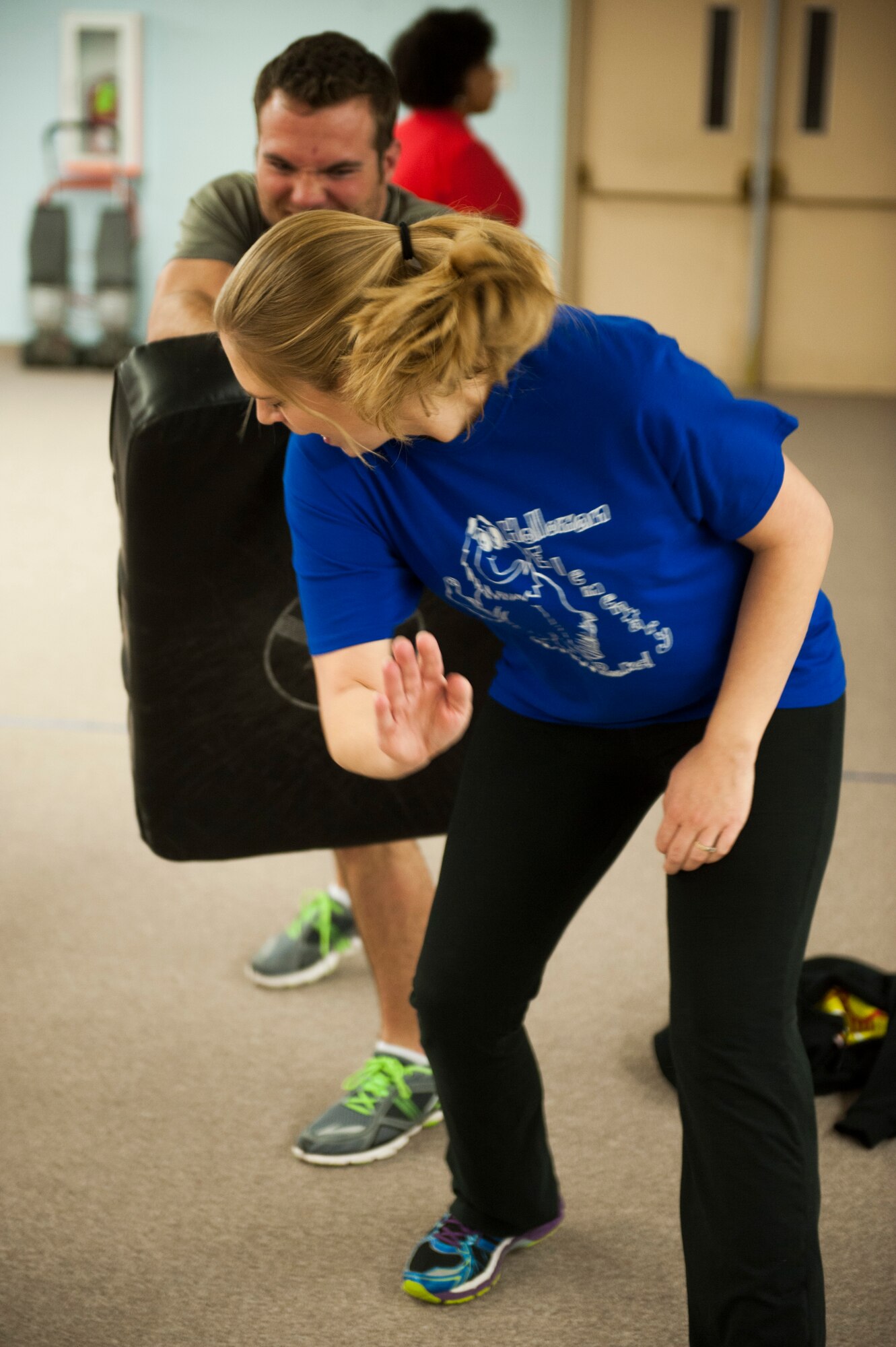 A Fear Adrenaline Stress Training participant practices a self-defense move against Will Vallee, Holloman Outdoor Recreation director, during FAST at Holloman Elementary School Jan. 29, 2015. The moves taught during FAST are designed to help people ward off someone they feel is threatening if they are ever in an uncomfortable or dangerous situation. (U.S. Air Force photo by Airman 1 Class Emily A. Kenney/Released)