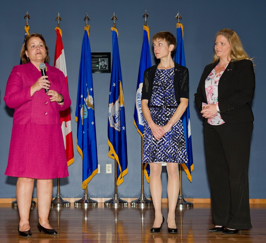 TYNDALL AIR FORCE BASE, Fla. – Sheree Etter (left) speaks of the importance of the Key Spouse Program during the recent Air Forces Northern Commander's Call at the Horizons Community Center.  Etter, Key Spouse Program mentor, introduces new representatives Julianna Saratsis and Tonya Statom. Both Saratsis and Statom were presented Key Spouse pins.  (U.S. Air Force Photo by Senior Airman Alex Echols III/Released/cropped)