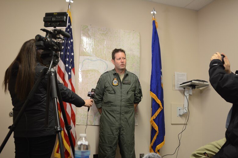 Royal Australian Air Force Group Capt. Carl Newman, commanding officer of the 84th Wing, answers questions from local media at Rosecrans Air National Guard Base in St. Joseph, Mo., Jan. 29, 2015. Newman was the keynote speaker during the 33rd annual Tactics and Intelligence Symposium hosted by the Advanced Airlift Tactics Training Center. (U.S. Air National Guard photo by Tech. Sgt. Michael Crane/Released)