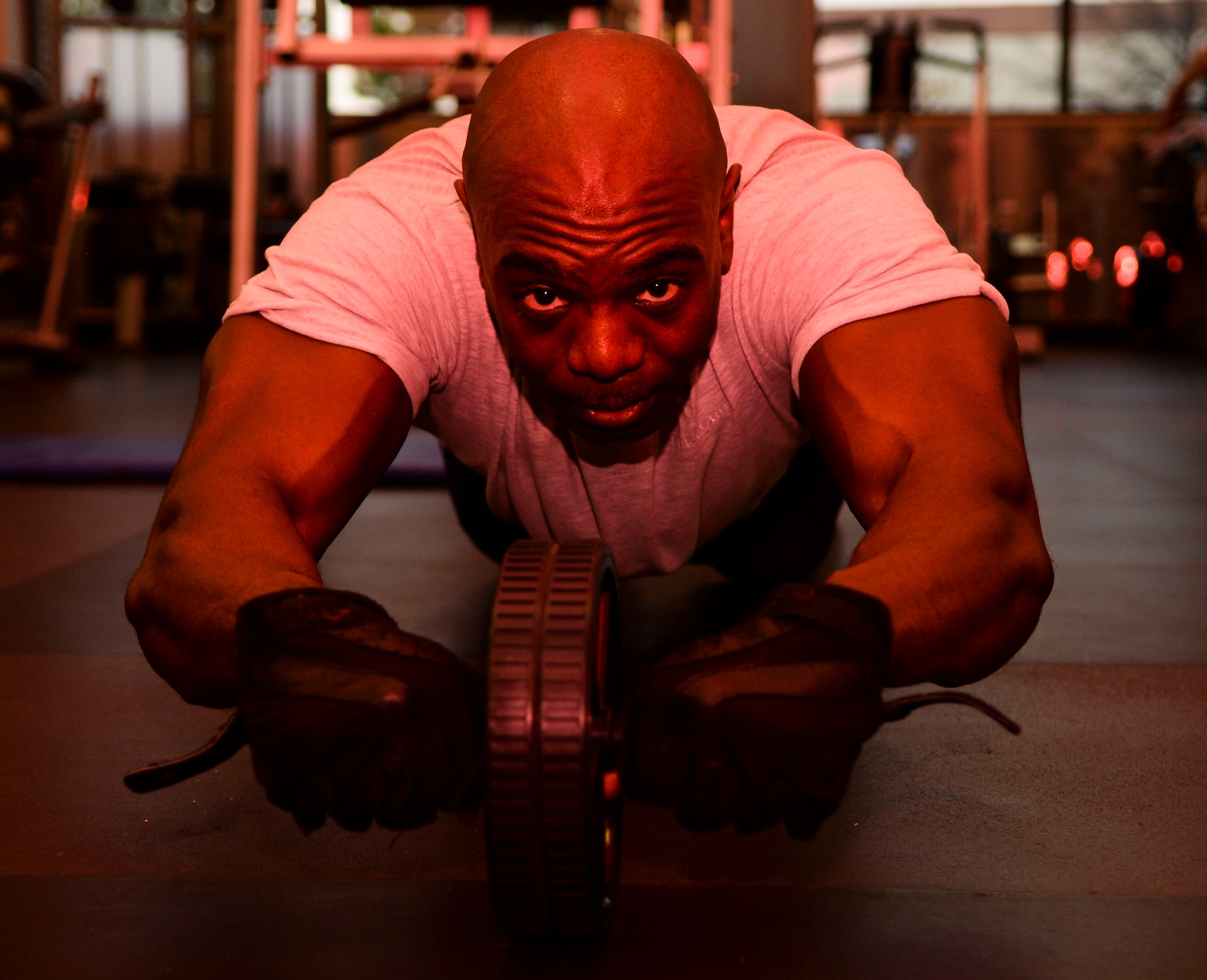 U.S. Air Force Master Sgt. Mackenzie Mercer, Air Combat Command Communications Support Squadron noncommissioned officer-in-charge, performs an abdominal exercise at Langley Air Force Base, Va., Jan. 30, 2015. Mercer relieves his stress at the gym by not only working out, but sharing his stressors with close friends who lift with him. (U.S. Air Force photo by Senior Airman Austin Harvill/Released)