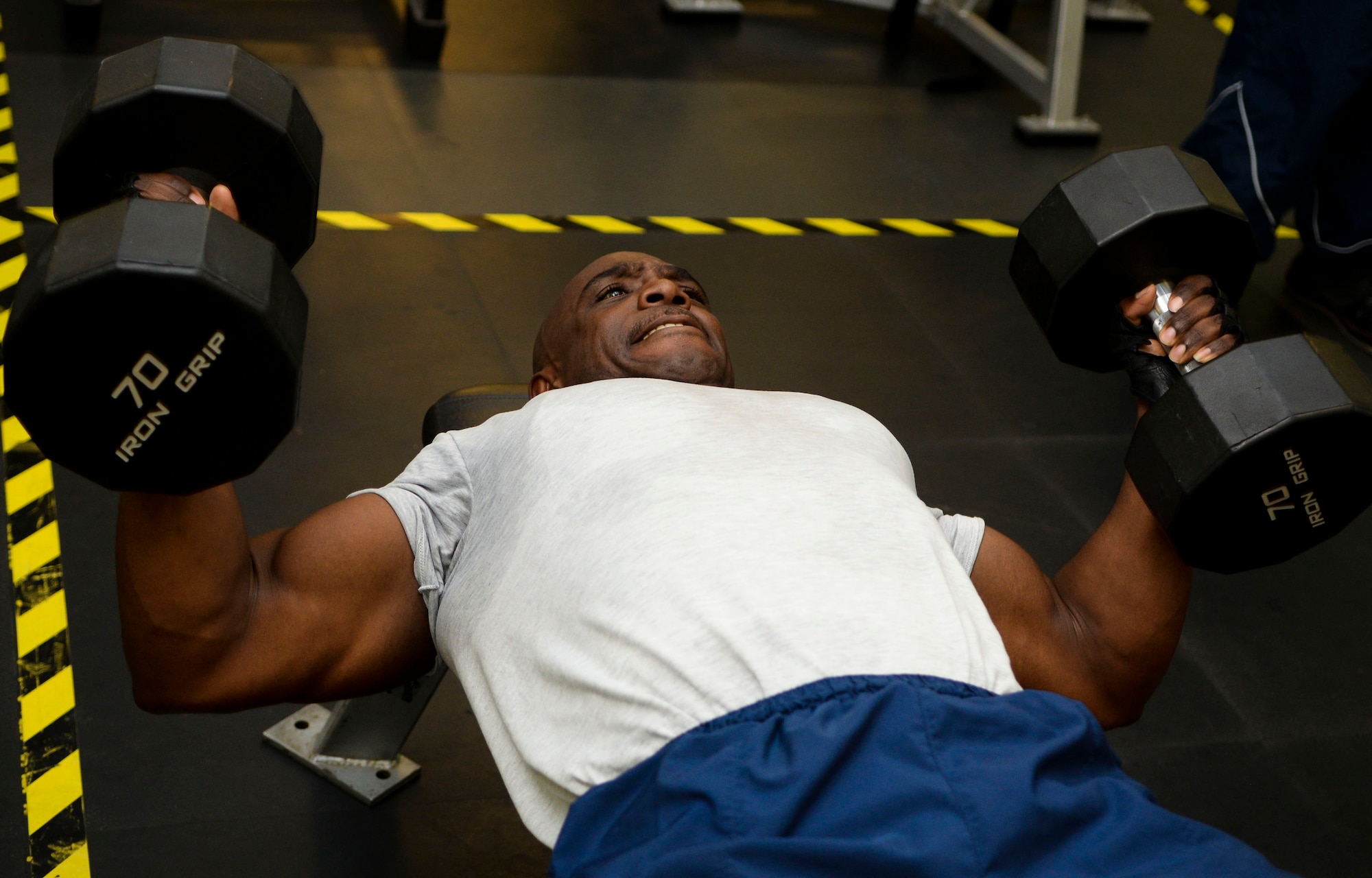 U.S. Air Force Master Sgt. Mackenzie Mercer, Air Combat Command Communications Support Squadron noncommissioned officer-in-charge, works out at Langley Air Force Base, Va., Jan. 30, 2015. Mercer said he exercises with others in his office to show them he also struggles, which he believes leads to better, more human relationships. (U.S. Air Force photo by Senior Airman Austin Harvill/Released)