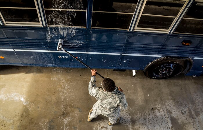 Airman 1st Class Jesse Brown, 628th Logistics Readiness Squadron vehicle operator, conducts a routine cleaning of a 44 passenger bus Jan. 28, 2015, at Joint Base Charleston, S.C. The buses are scheduled to be washed three times a month, unless additional cleaning is needed, by members of the LRS vehicle operations. The buses are used to transport individuals (Aircrews, tours, etc.) to and from the flight line. (U.S. Air Force Photo / Senior Airman Tom Brading )