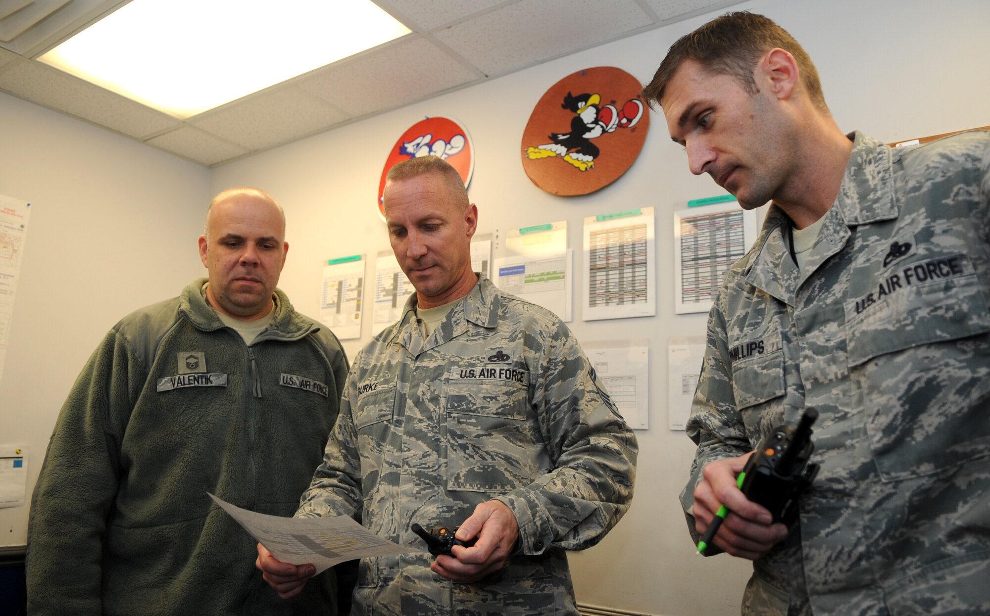Senior NCO of the Year: Senior Master Sgt. Eric Burke (center), 334th Aircraft Maintenance Unit superintendent, reviews the 334th AMU’s weekly schedule with Senior Master Sgt. Frank Valentik, 334th AMU lead production superintendent, and Master Sgt. Richard Phillips, 334th AMU production superintendent, at Seymour Johnson Air Force Base, North Carolina, Jan. 29, 2015. "Knowing we are defending freedom with an aging fleet and less people and money, makes it more important to take care of our best weapon, our Airmen." (U.S. Air Force photo/Senior Airman Ashley J. Thum)