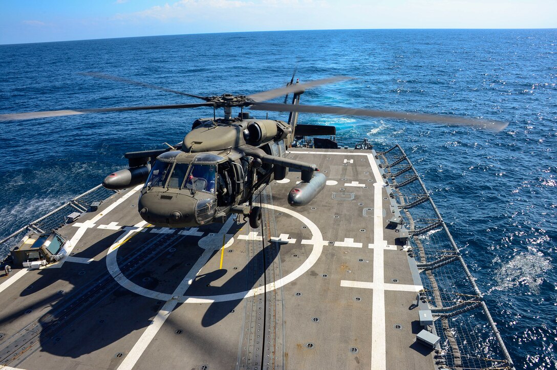 A UH-60 helicopter, assigned to the 1st Battalion, 228th Aviation Regiment makes an approach to the USS Kauffman during deck landing qualifications off the coast of  Honduras, Feb. 1, 2015.  The 1-228th Avn. Reg. aircrew participated in deck landing qualifications on board the USS Kauffman to qualify pilots and crew chiefs on shipboard operations.  Kauffman is on its final scheduled deployment to the U.S. Southern Command area of responsibility supporting multinational, counter-narcotics operation known as Operation Martillo. (U.S. Air Force photo/Tech. Sgt. Heather Redman)