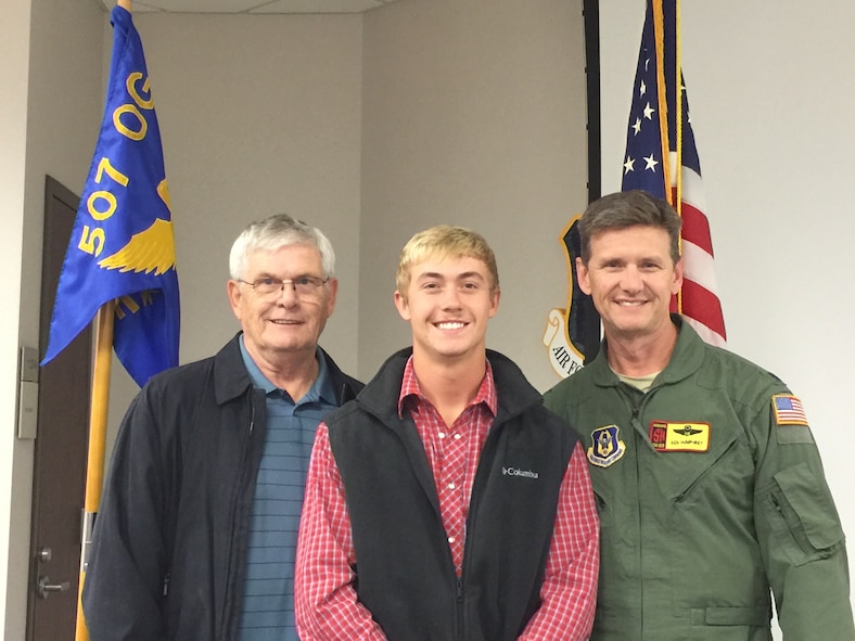 All three generations of Humphreys pose for a picture at the enlistment ceremony for Kennedy Humphrey (middle) with his father Lt. Col. Ken Humphrey (right) and grandfather retired Senior Master Sgt. Stephen Humphrey.  All three generations have served in the 507th Air Refueling Wing throughout the years.  (Courtesy photo)  