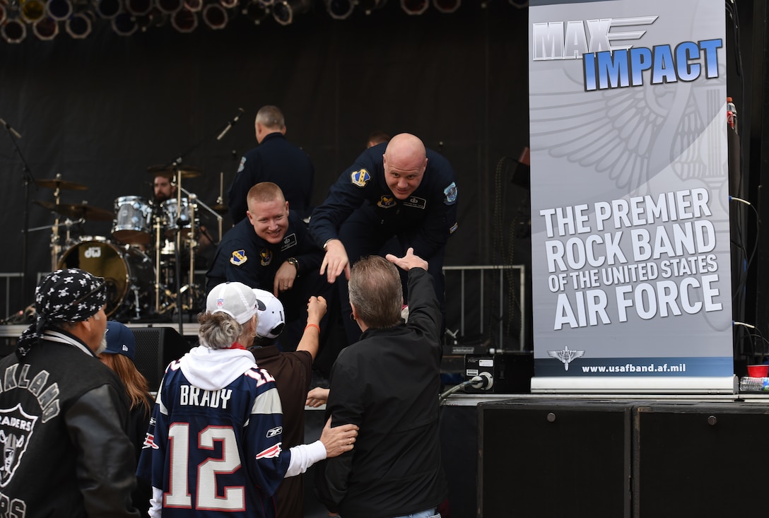 Master Sgt. Jonathan McPherson, U.S. Air Force band pianist, left, and Senior Master Sgt. Ryan Carson, U.S. Air Force band vocalist, right, shake hands of Super Bowl XLIX fans after their show at Westgate Entertainment District in Glendale, Az., Feb. 1, 2015. The band’s mission is to honor those who have served, inspire American citizens to heighten patriotism and services, and positively impact the global community on behalf of the USAF and United States of America. (U.S. Air Force photo/ Senior Airman Nesha Humes)