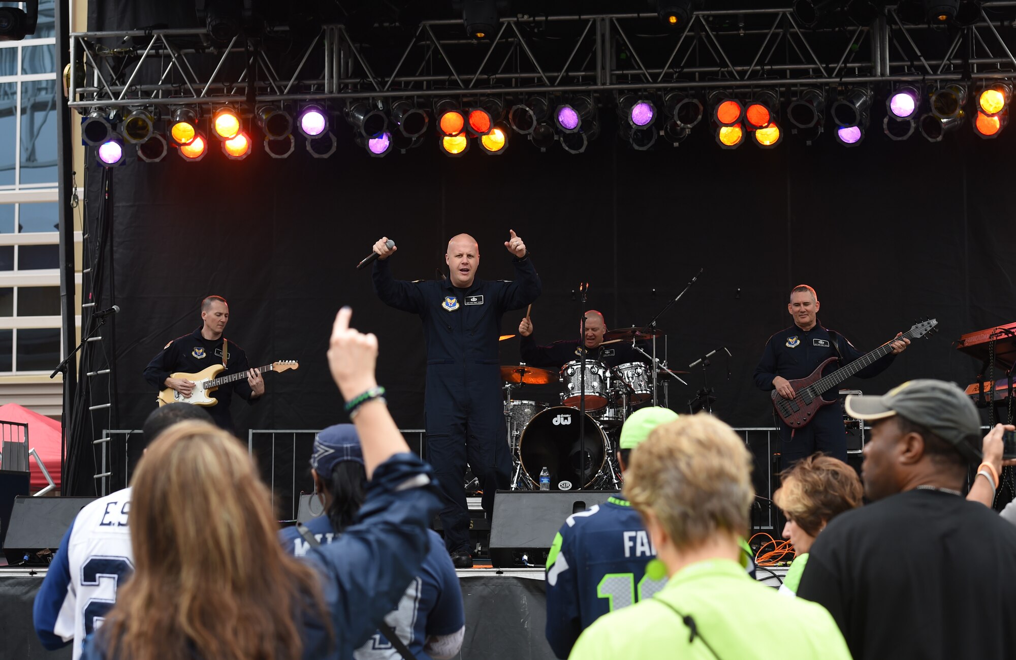 Senior Master Sgt. Ryan Carson, the U.S. Air Force rock band Max Impact vocalist, sings for Super Bowl XLIX fans at Westgate Entertainment District in Glendale, Az., Feb. 1, 2015. The band’s mission is to honor those who have served, inspire American citizens to heighten patriotism and services and positively impact the global community on behalf of the Air Force and United States of America. (U.S. Air Force photo/ Senior Airman Nesha Humes)