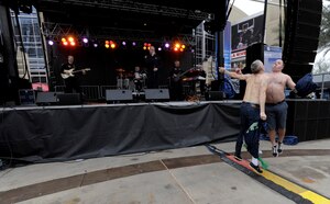 Seattle Seahawk fans bump chests during Max Impact’s performance at Westgate Entertainment District in Glendale, Az., Feb. 1, 2015. The restaurant, bar and shopping plaza is less than half a mile from The University of Phoenix Stadium, home of Super Bowl XLIX. (U.S. Air Force photo/ Senior Airman Nesha Humes)