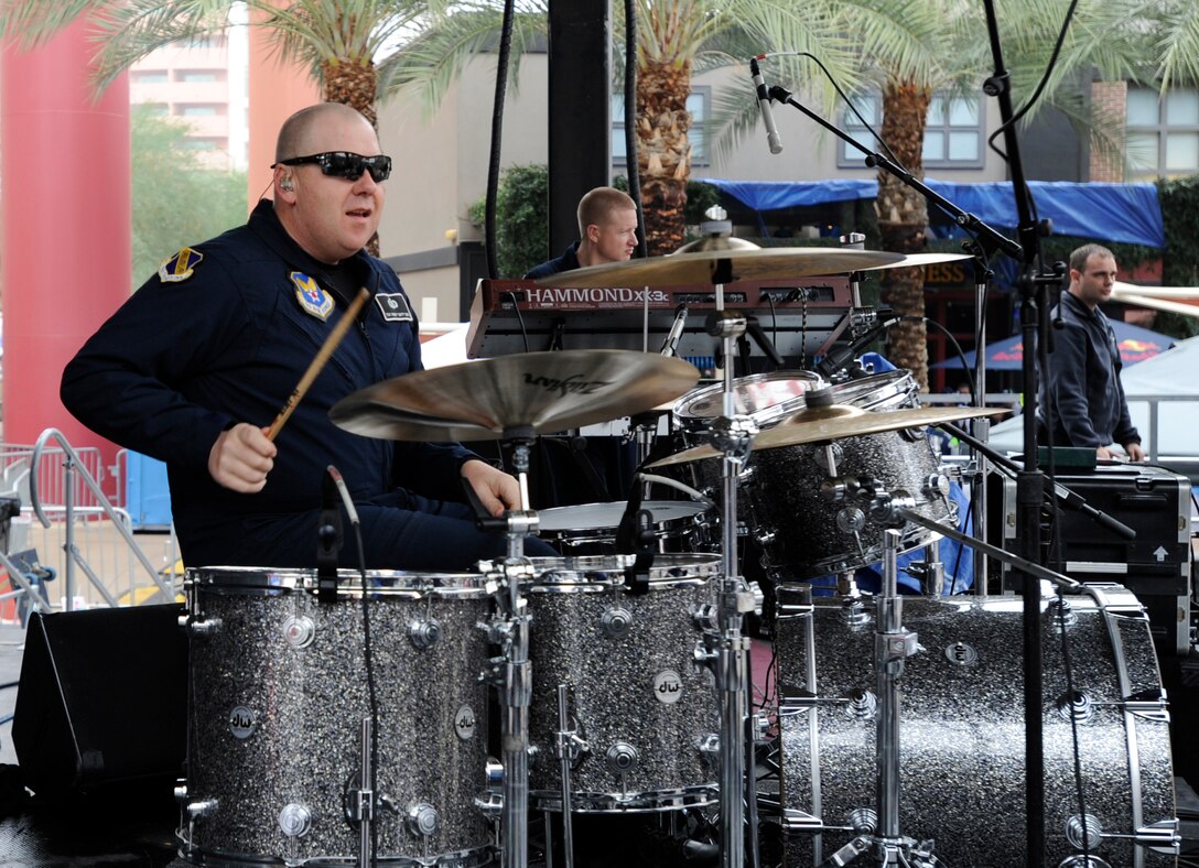 Tech Sgt. Robert Smith, U.S. Air Force rock band Max Impact percussionist, plays for Super Bowl XLIX fans at Westgate Entertainment District in Glendale, Az., Feb. 1, 2015. The band’s mission is to honor those who have served, inspire American citizens to heighten patriotism and services, and positively impact the global community on behalf of the Air Force and United States of America. (U.S. Air Force photo/ Senior Airman Nesha Humes)