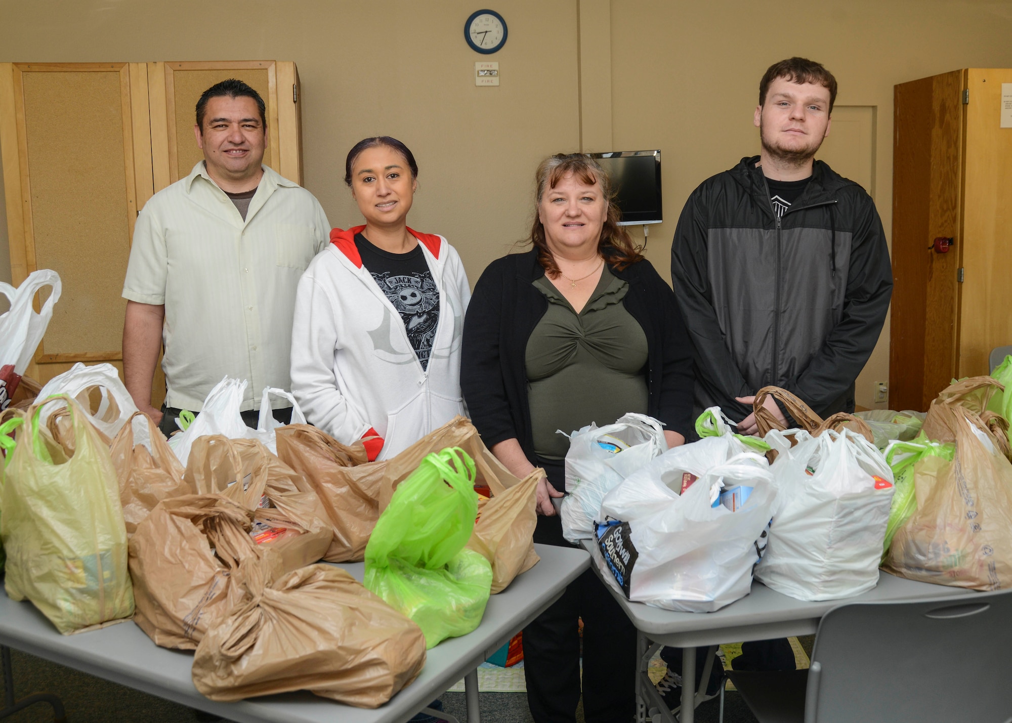 Move the food staff and volunteers (from left to right) Jerry Mallonee, Sonia Burgess, Janet Till and Joshua Oakes, gave away 87 bags of food during the Move the Food event Jan. 28. The volunteers pack the bags of food in the pantry, then chapel staff members Burgess and Till deliver them to families in need. (U.S. Air Force photo by Rebecca Amber)