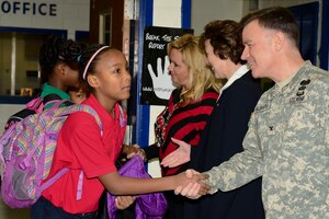 U.S. Army Col. William Galbraith, 733rd Mission Support Group commander, greets a student at the Achievable Dream Academy Elementary School in Newport News, Va., Jan. 29, 2015. Galbraith and his command team visited the school in hopes of reestablishing an ongoing relationship with the school that allows Soldiers to volunteer on a daily basis. (U.S. Air Force photo by Senior Airman Kimberly Nagle/Released)