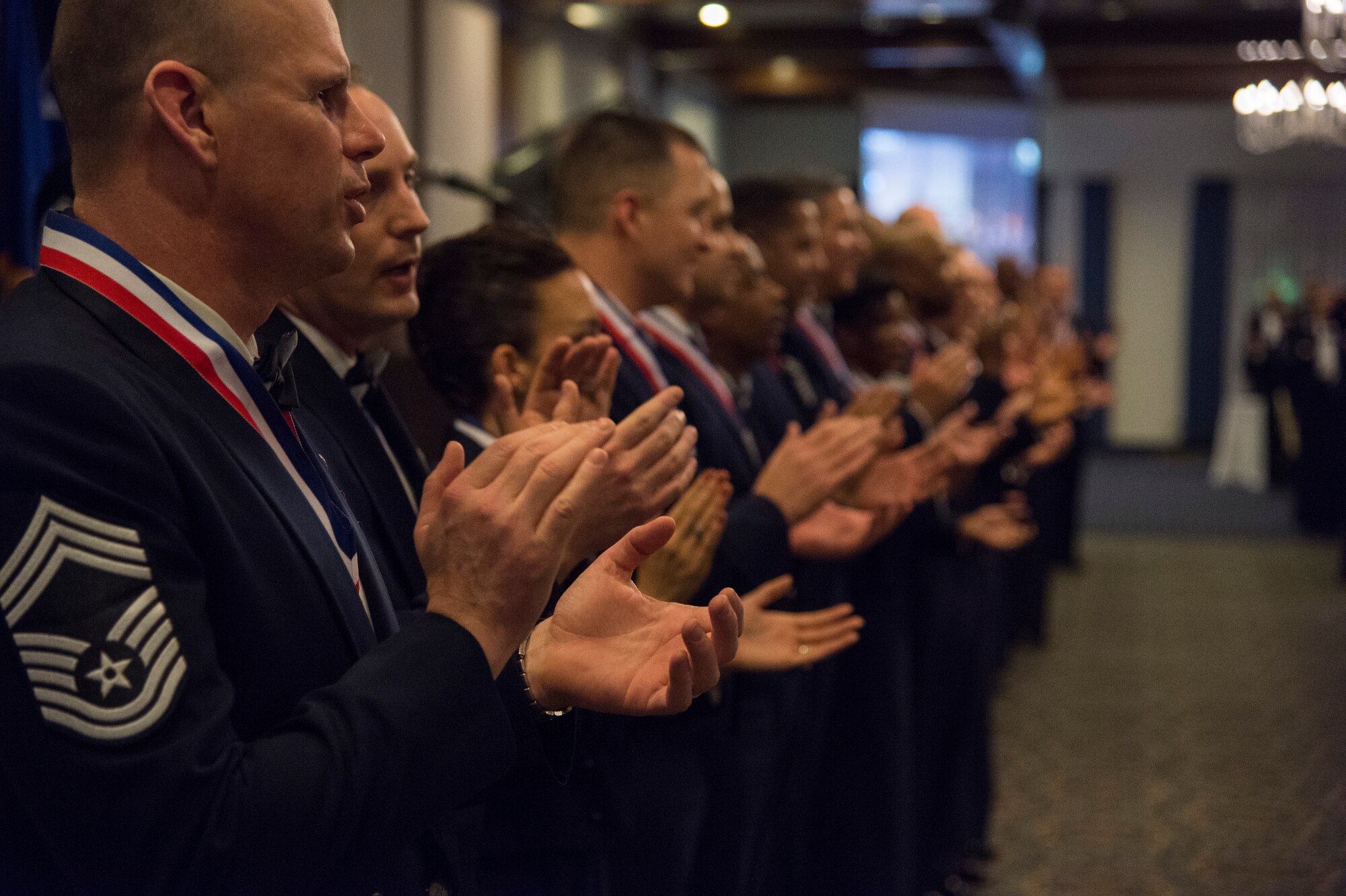 Newly selected chief master sergeants sing the Air Force Song during a recognition Ceremony at Ramstein Air Force Base, Germany, Jan. 30, 2015. Thirty six newly-selected chief master sergeants throughout Ramstein were recognized during the ceremony. (U.S. Air Force photo/Senior Airman Damon Kasberg)