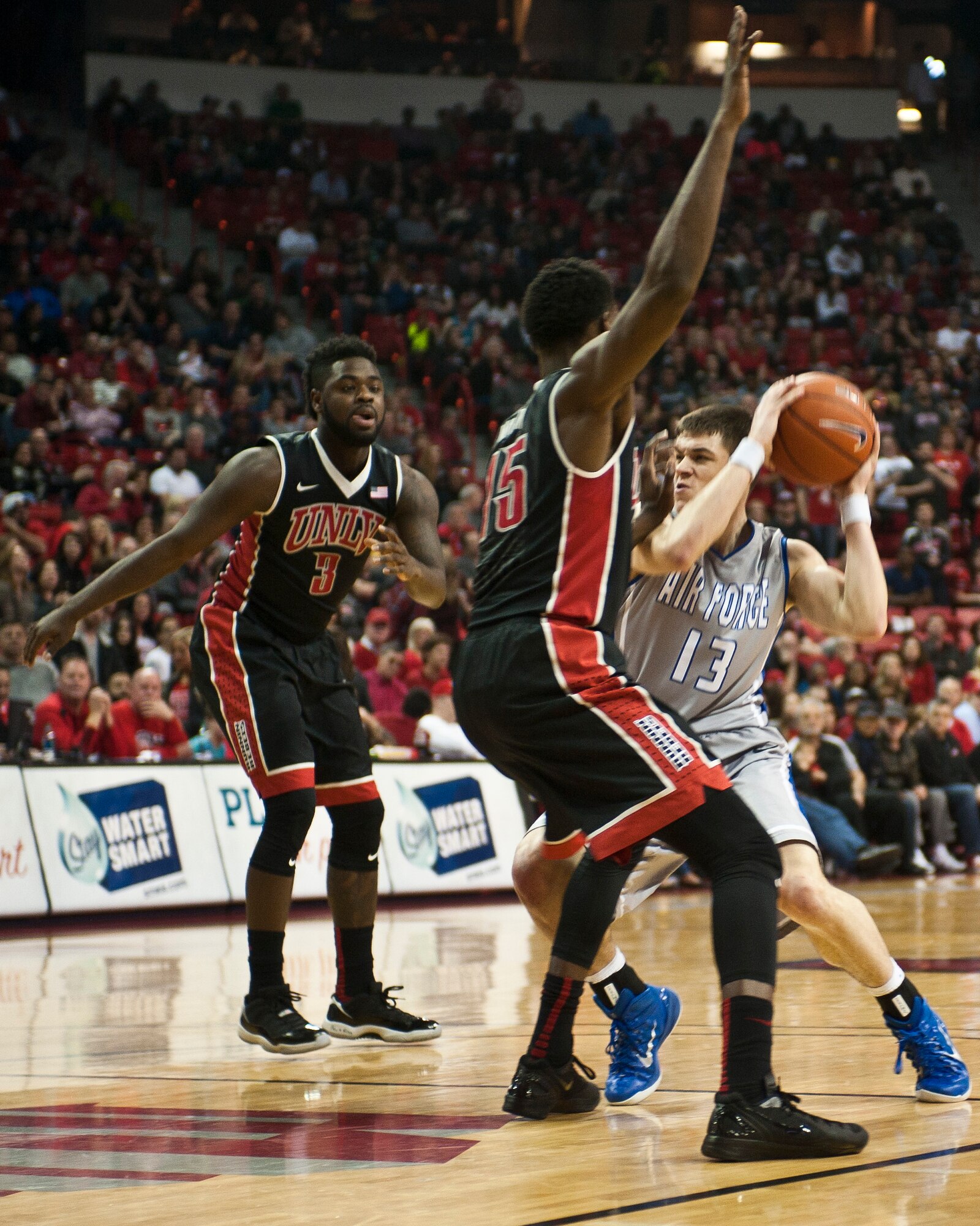 Air Force Academy guard Matt Mooney looks for an opening during a game against the University of Nevada-Las Vegas at the Thomas and Mack Center in Las Vegas Jan. 31, 2015. Mooney, who is only a freshman, has earned more playing time as the season has progressed, and was lauded by Air Force head coach Dave Pilipovich for his play despite his lack of college basketball experience. (U.S. Air Force photo by Staff Sgt. Siuta B. Ika)