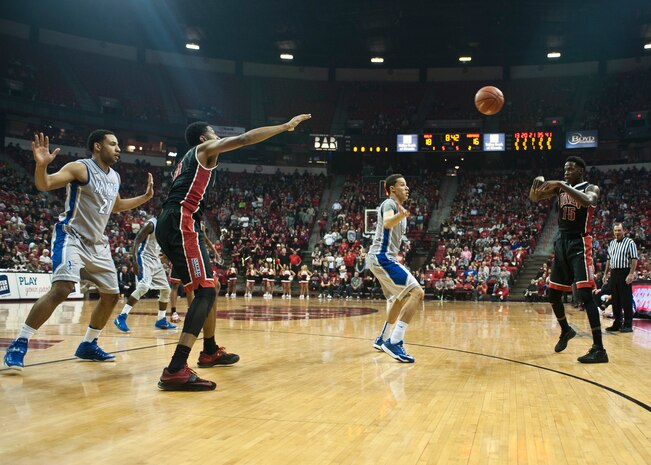 Air Force Academy players defend a pass between University of Nevada-Las Vegas players during a game at the Thomas and Mack Center in Las Vegas Jan. 31, 2015. As part of the Mountain West Conference, Air Force and UNLV play each other twice a year during the regular season. (U.S. Air Force photo by Staff Sgt. Siuta B. Ika)