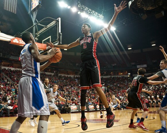 University of Nevada-Las Vegas forward Christian Wood defends an inbound pass from Air Force Academy forward Justin Hammonds during a game at the Thomas and Mack Center in Las Vegas Jan. 31, 2015. At 6’11”, Wood is the tallest player on the UNLV roster. (U.S. Air Force photo by Staff Sgt. Siuta B. Ika)