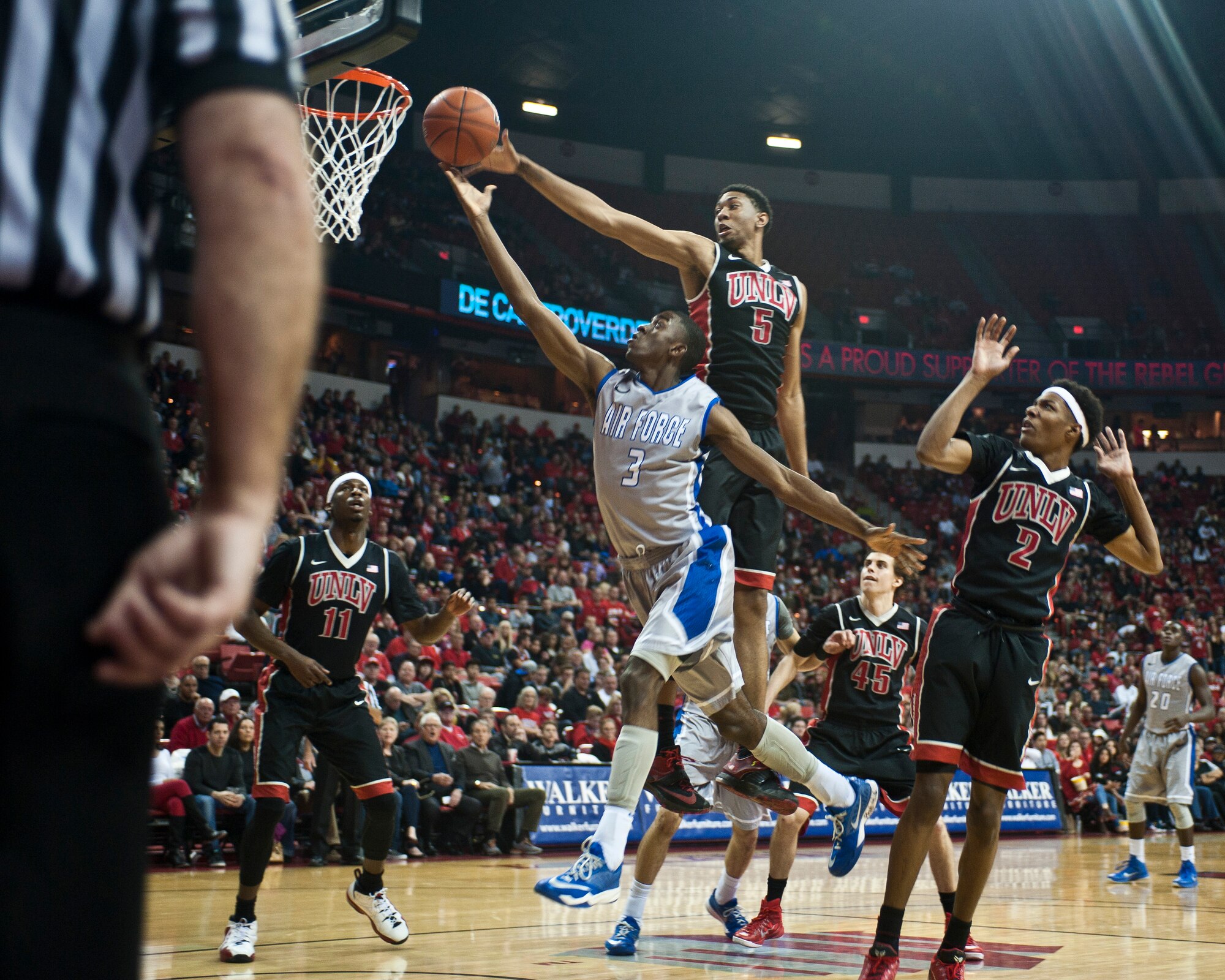 Air Force Academy forward Justin Hammonds lays the ball into the hoop while avoiding University of Nevada-Las Vegas forward Christian Wood during a game at the Thomas and Mack Center in Las Vegas Jan. 31, 2015. Hammonds led the team with 15 points and six rebounds in Air Force’s 74-63 loss. (U.S. Air Force photo by Staff Sgt. Siuta B. Ika)