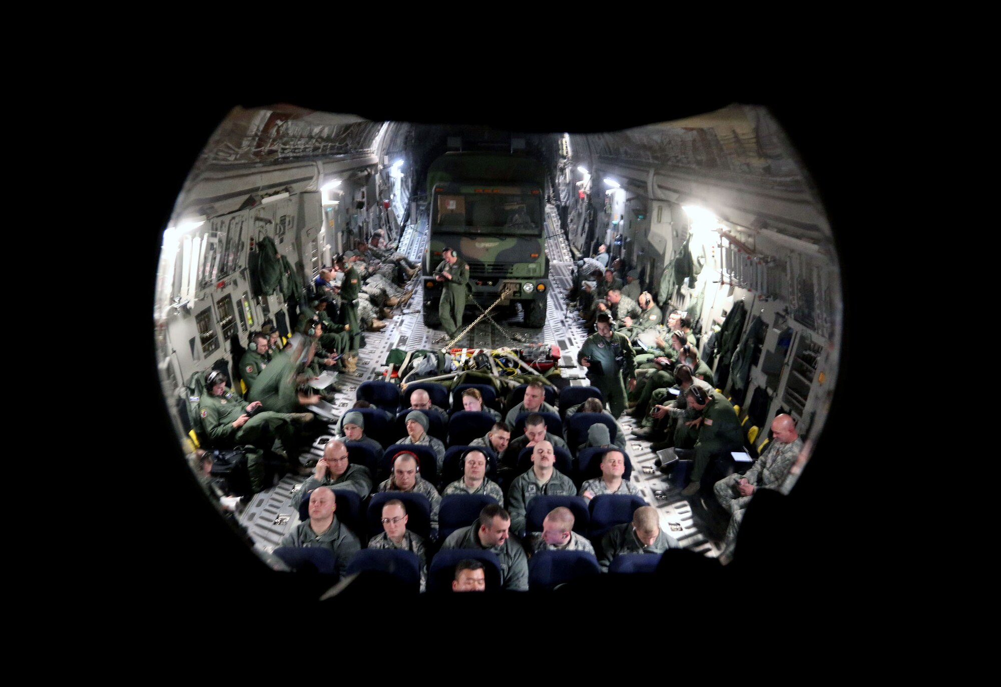MADISON, Wis. – Soldiers from the 646th Regional Support Group HHC get some rest while traveling to annual training as Airmen from the 445th Aeromedical Evacuation Squadron get some training time on a C-17 Globemaster III Jan. 18, 2015. The aircraft was flown by Airmen from the 89th Airlift Squadron, Wright-Patterson Air Force Base, Ohio. The aircrew provided transport for the 646th RSG HHC on their way to annual training in Virginia. (U.S. Army photo by Sgt. 1st Class Alexander Kartanos)