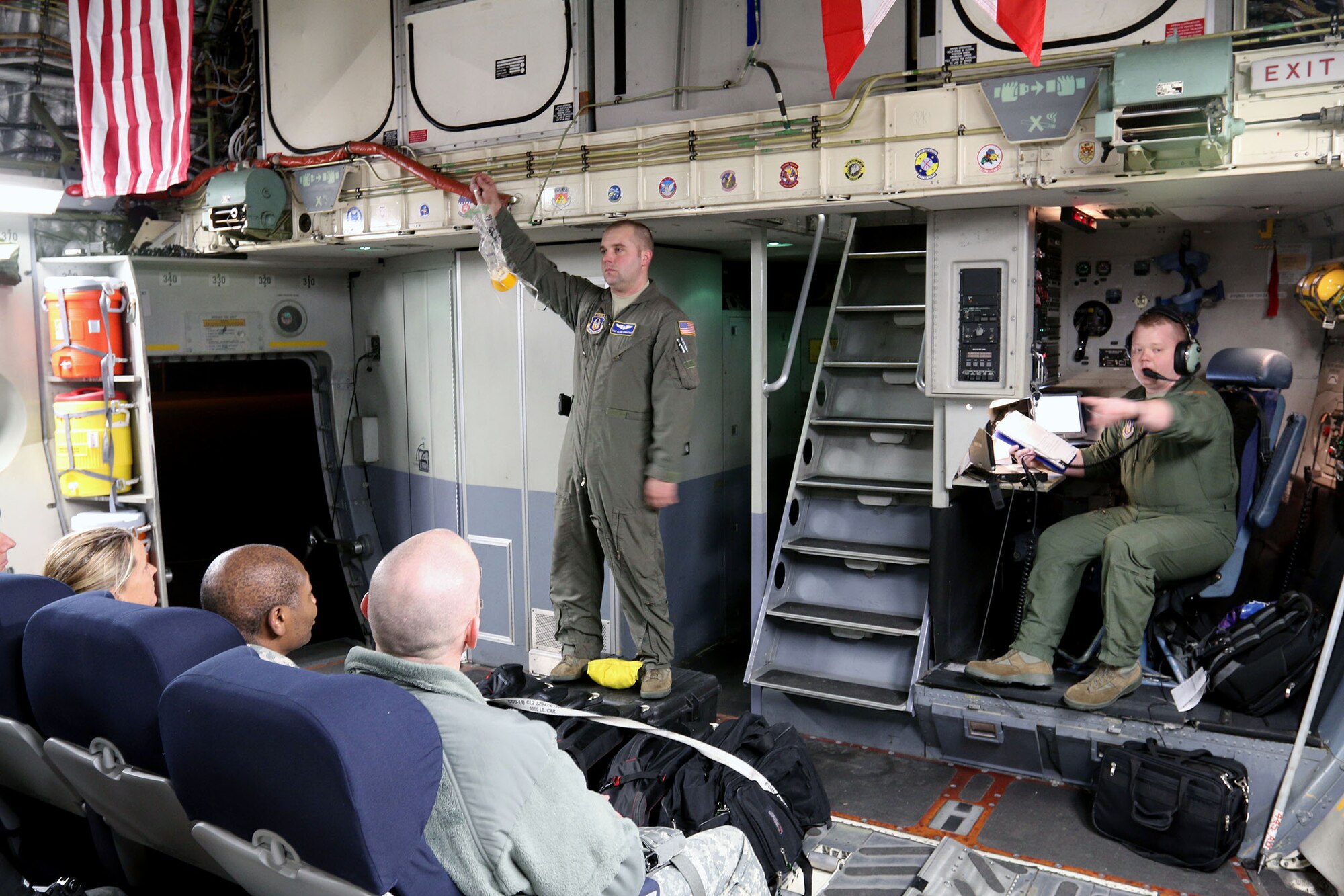 MADISON, Wis. – Tech. Sgt. Blake LeMaster (left) and Senior Airman Zach Webb (right), 89th Airlift Squadron, Wright-Patterson Air Force Base, Ohio, provide the C-17 Globemaster III inflight safety briefing to Soldiers from the 646th Regional Support Group HHC, Madison, Wis., Jan. 18, 2015. The 89th AS provided transportation for the unit’s annual training. (U.S. Army photo by Sgt. 1st Class Alexander Kartanos)