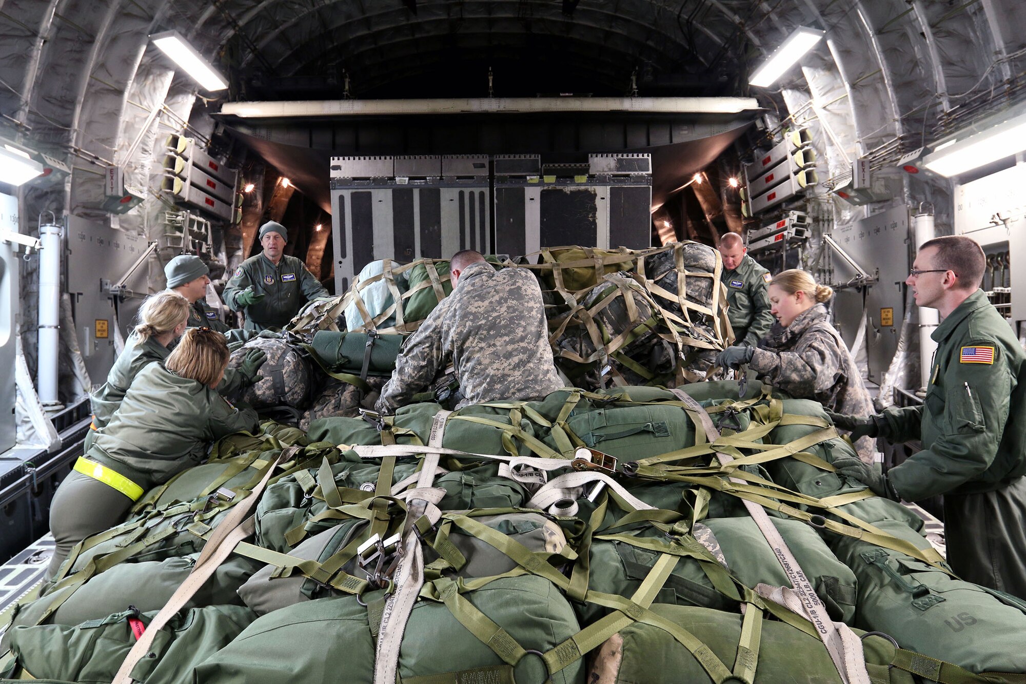 MADISON, Wis. – Soldiers from the 646th Regional Support Group HHC and Airmen from the 445th Aeromedical Evacuation Squadron strap down gear and equipment on a 445 AW C-17 Globemaster III in Madison, Wis., Jan. 18, 2015. The 89th Airlift Squadron out of Wright-Patterson Air Force Base, Ohio, provided the 646th Regional Support Group HHC with transportation to their annual training in Virginia. (U.S. Army photo by Sgt. 1st Class Alexander Kartanos)