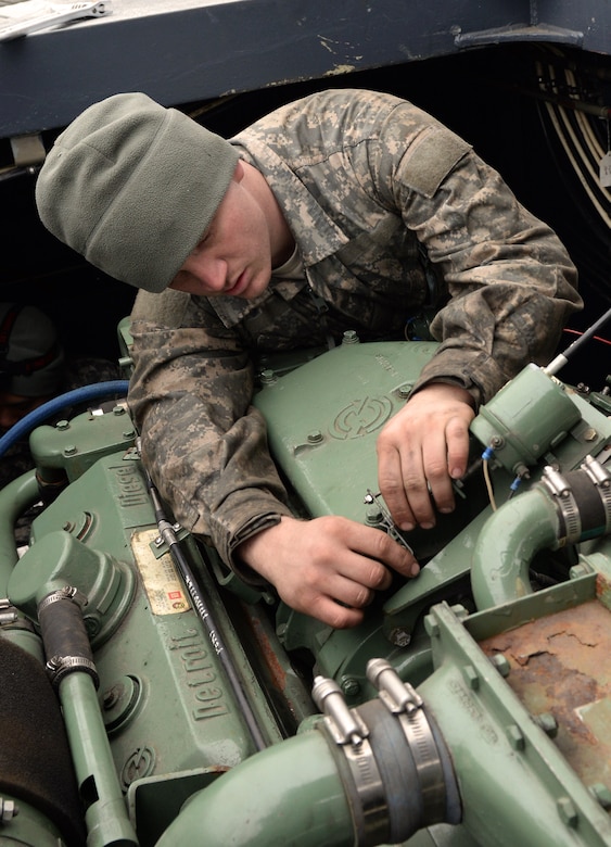 U.S. Army Pvt. Jeffery Kemp, 331st Transportation Company, 11th Transportation Battalion, 7th Transportation Brigade (Expeditionary) watercraft engineer, repairs the engine of a side-loaded warping tug boat at Fort Eustis, Va., Jan. 21, 2015. Kemp transitioned from Advanced Individual Training at Fort Eustis to permanent party after he graduated in November 2014. (U.S. Air Force photo by Staff Sgt. Teresa J. Cleveland/Released)