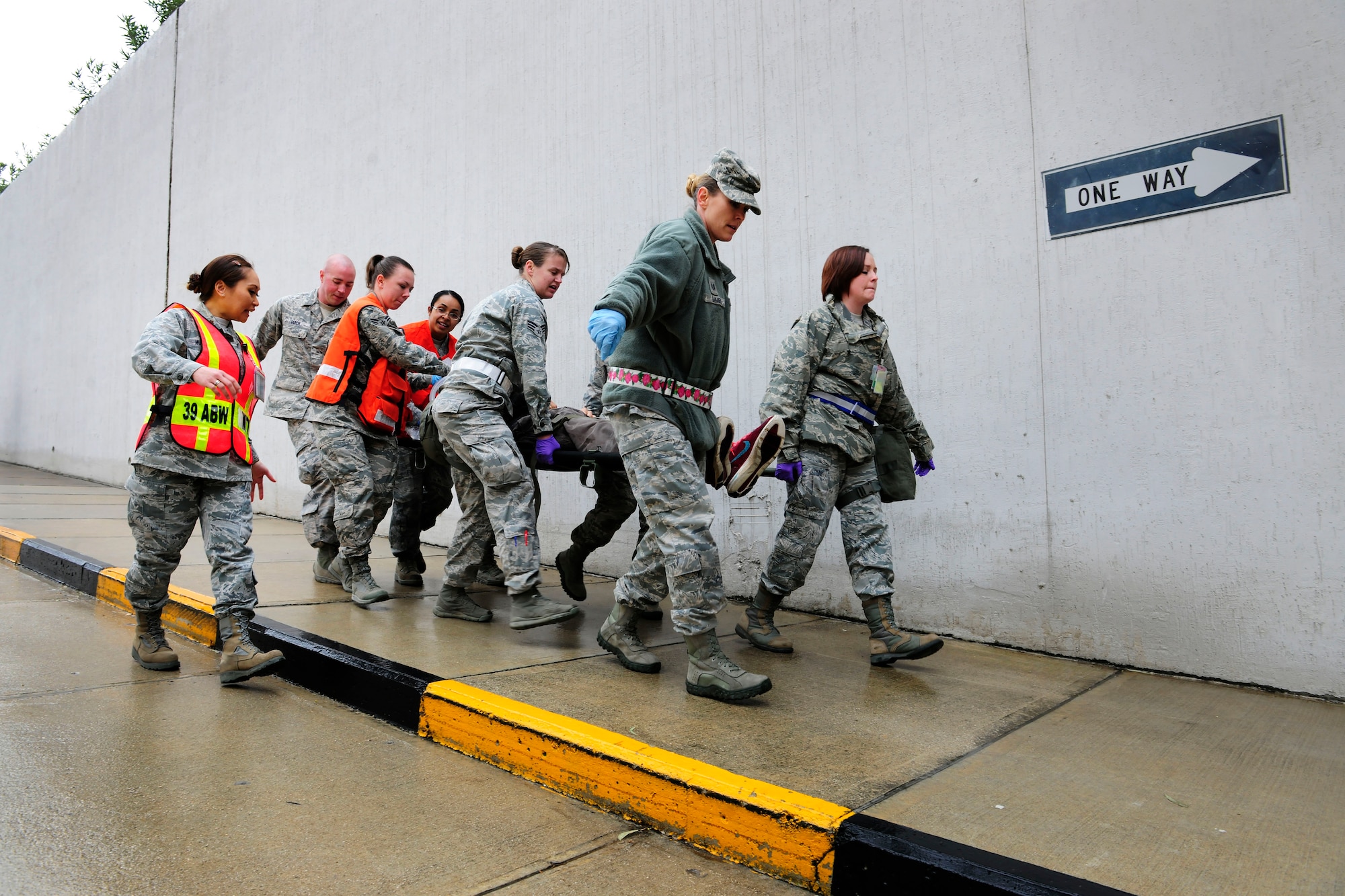 Airmen from the 39th Medical Group carry a patient on a stretcher into the base clinic during a base-wide exercise Jan. 28, 2015, at Incirlik Air Base, Turkey. The exercise tested the 39th Medical Groups’ response capabilities to a mass casuality event in both the transferring and care of patients. (U.S. Air Force photo by Senior Airman Krystal Ardrey/Released)