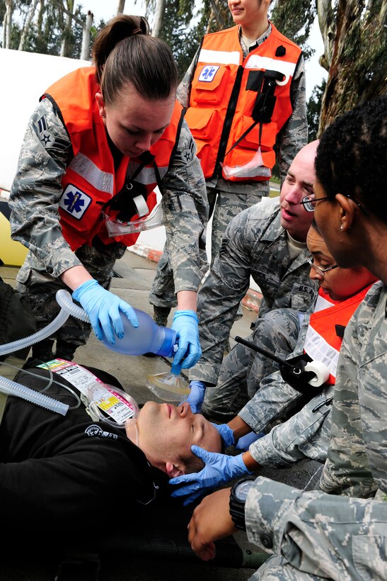 Airman 1st Class Jessica Hoyle, 39th Medical Operations Squadron medical technician, simulates providing oxygen to a patient during a base-wide exercise Jan. 28, 2015, at Incirlik Air Base, Turkey. As part of the exercise multiple patients were transported to the base clinic with simulated injuries. (U.S. Air Force photo by Senior Airman Krystal Ardrey/Released)