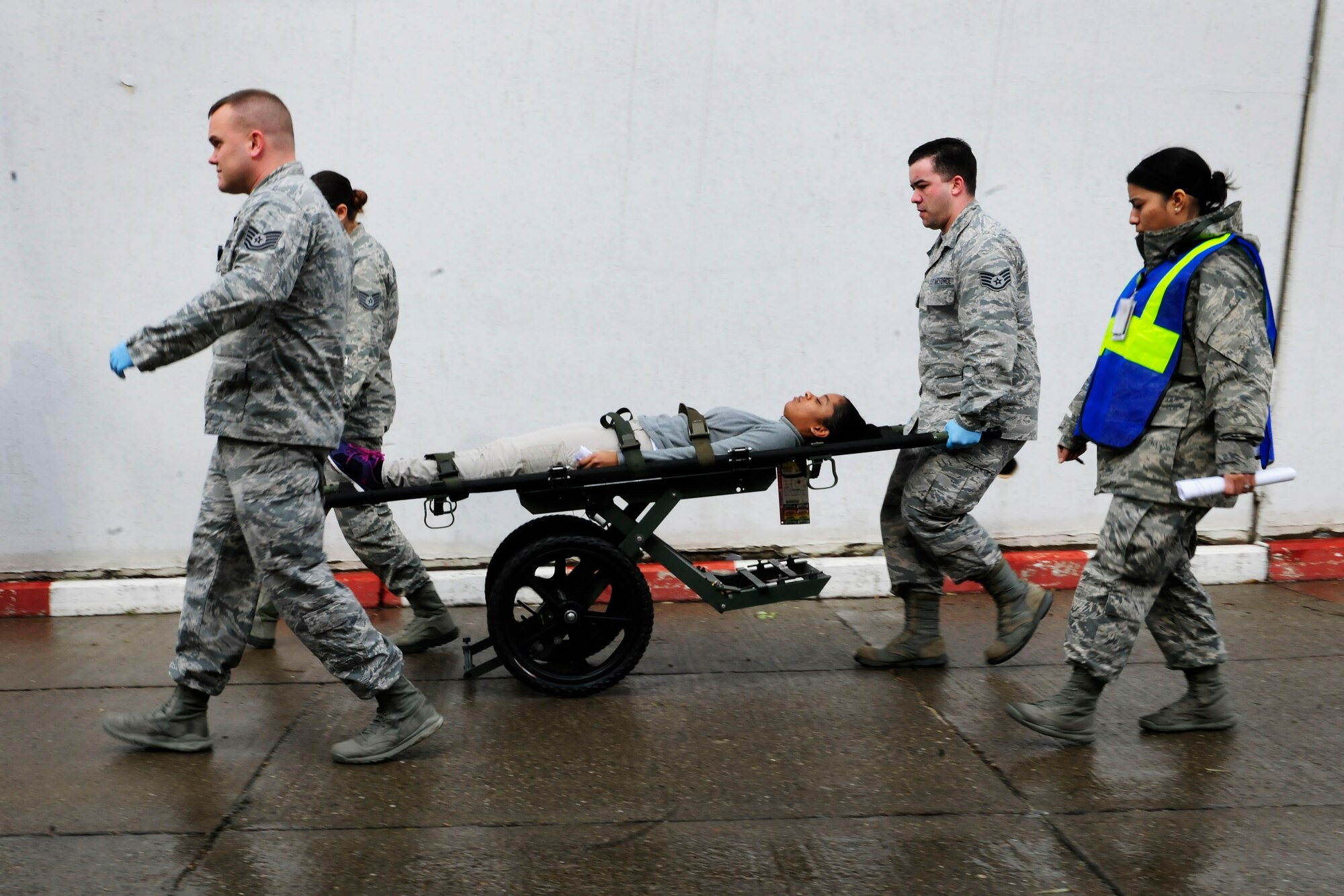 Airmen from the 39th Medical Group wheel a patient on a stretcher into the base clinic during a base-wide exercise Jan. 28, 2015, at Incirlik Air Base, Turkey. The exercise tested the 39th Medical Groups’ response capabilities to a mass casuality event in both the transferring and care of patients. (U.S. Air Force photo by Senior Airman Krystal Ardrey/Released)