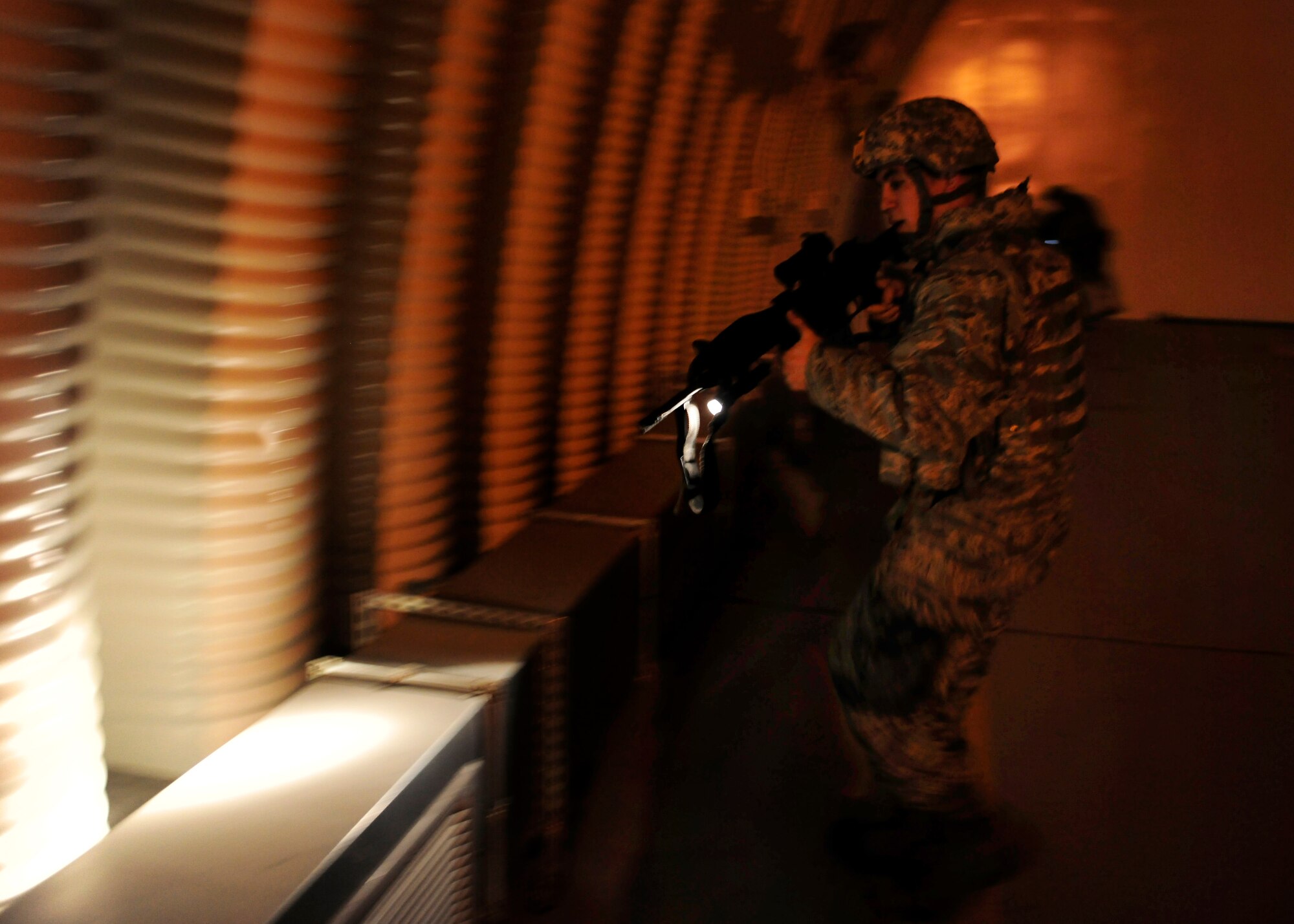 First Lieutenant Carlos Moralejo, 39th Security Forces Squadron flight commander, searches an aircraft shelter after a tactical entry during a base-wide exercise Jan. 28, 2015, at Incirlik Air Base, Turkey. As part of the exercise 39th SFS defenders tactically entered and searched the inside of the shelter. (U.S. Air Force photo by Senior Airman Krystal Ardrey/Released)