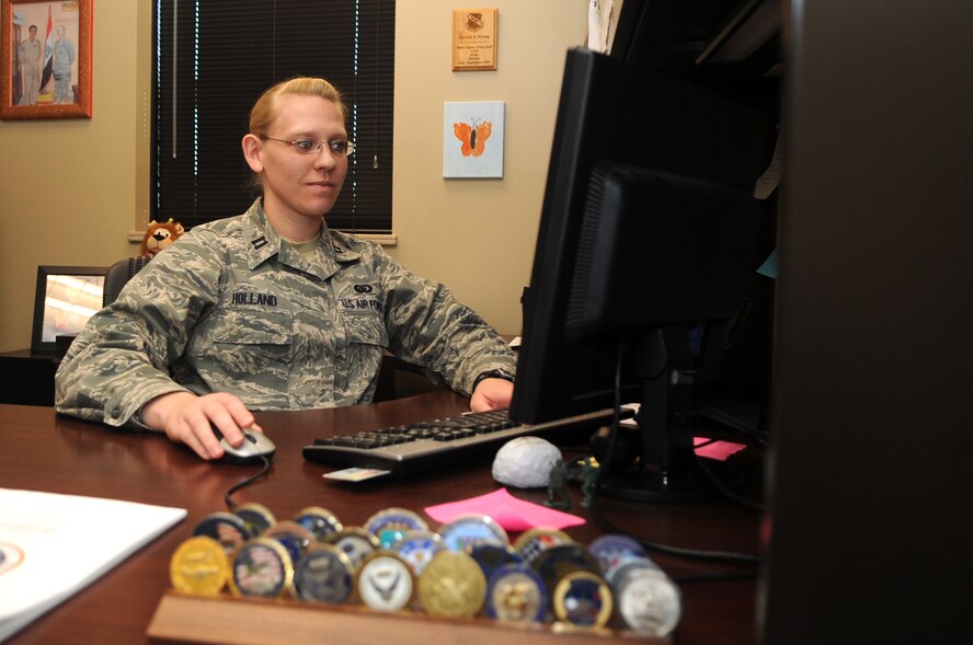 Company Grade Officer of the Year: Capt. Erin Holland, 4th Force Support Squadron Manpower and Personnel Flight commander, distributes work assignments at Seymour Johnson Air Force Base, North Carolina, Jan. 28, 2015. “You’re only as strong as the people you work with. I wouldn’t be where I am without them kicking butt every day.” (U.S. Air Force photo/Senior Airman Ashley J. Thum)