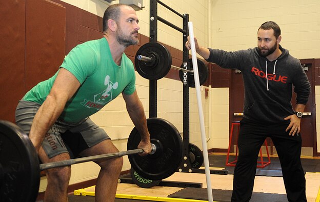 Senior Grade Civilian of the Year: Joseph Gonzalez (right), 4th Aerospace Medicine Squadron health promotions coordinator, gauges the bar path of a snatch lift by Josh Geeson, former service member and spouse of a member of Team Seymour, at Seymour Johnson Air Force Base, North Carolina, Jan. 30, 2015. “It literally wasn’t me. I’m only one piece of the puzzle. I couldn’t have done it without the people who were willing to accept my help.” (U.S. Air Force photo/Senior Airman Ashley J. Thum)
