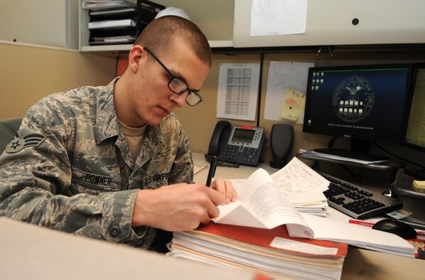 Volunteer of the Year: Senior Airman Devin Powner, 4th Contracting Squadron contract administrator, reviews documents to award a contract at Seymour Johnson Air Force Base, North Carolina, Jan. 28, 2015. “I owe a lot to my wife for supporting me while I was out volunteering and to the Exceptional Airmen Gaining Leadership and Expeditionary Skills for helping me with that drive to serve.” (U.S. Air Force photo/Senior Airman Ashley J. Thum)