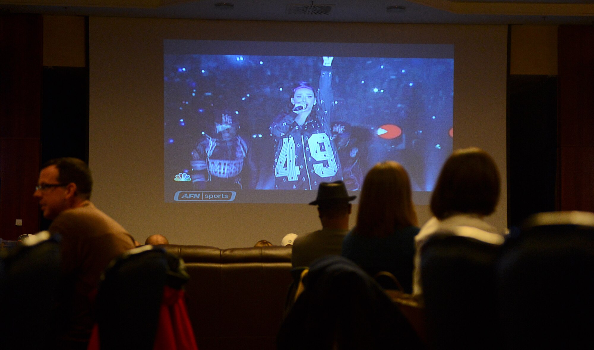 Members of the Spangdahlem community watch the half-time show of Superbowl XLIX at Club Eifel on Spangdahlem Air Base, Germany, Feb. 2, 2014. The main performing artist for the half-time show was Katy Perry, a current pop artist. The event was free to attend and open to everyone. (U.S. Air Force photo by Airman 1st Class Luke Kitterman/Released)