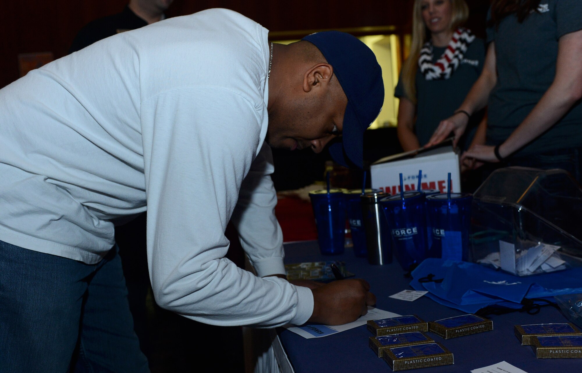 A member of the Spangdahlem community fills out an information card after winning a raffle prize during the showing of Superbowl XLIX at Club Eifel on Spangdahlem Air Base, Germany, Feb. 2, 2014. The prizes were donated by sponsors and included electronics, vacations and more. (U.S. Air Force photo by Airman 1st Class Luke Kitterman/Released)
