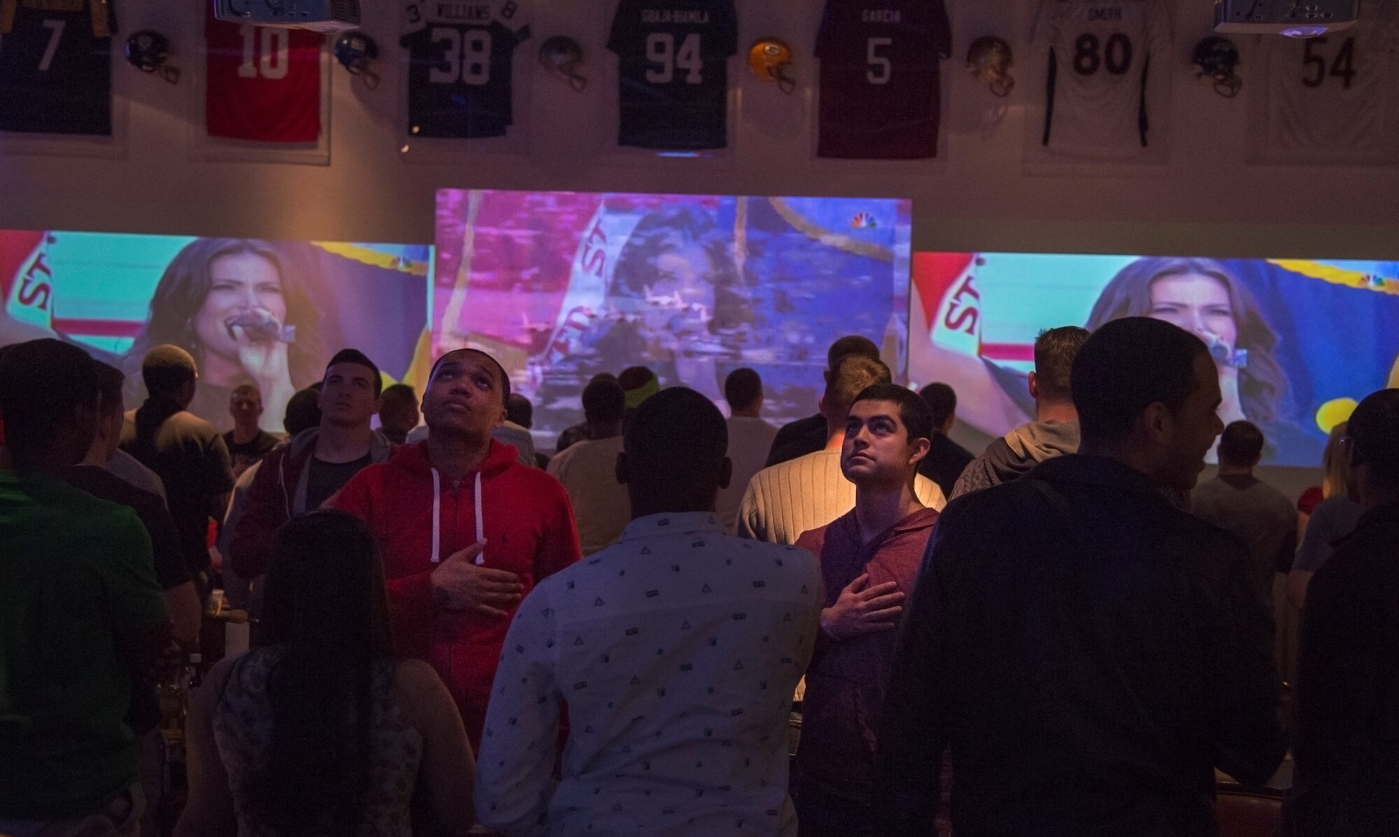 Fans stand during the U.S. National Anthem prior to kickoff at Ramstein Air Base, Germany, Feb. 1, 2015. Members of the Kaiserslautern Military Community watched the super bowl throughout Ramstein, staying up until the early morning to see who would take home the championship. (U.S. Air Force photo/Senior Airman Damon Kasberg)