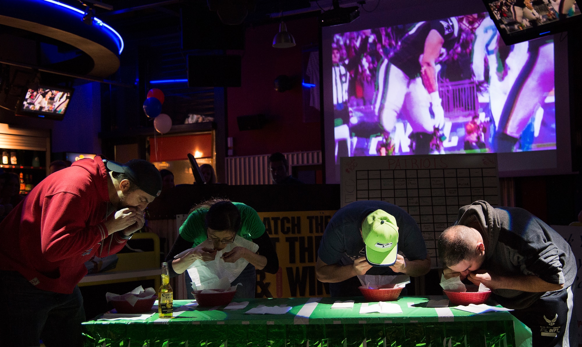 Fans participate in a hot-wing-eating contest prior to the start of Super Bowl XLIX at Ramstein Air Base, Germany, Feb. 1, 2015. Servicemembers throughout the Kaiserslautern Military Community stayed up to 12:30 a.m. to watch the start of the super bowl. (U.S. Air Force photo/Senior Airman Damon Kasberg)