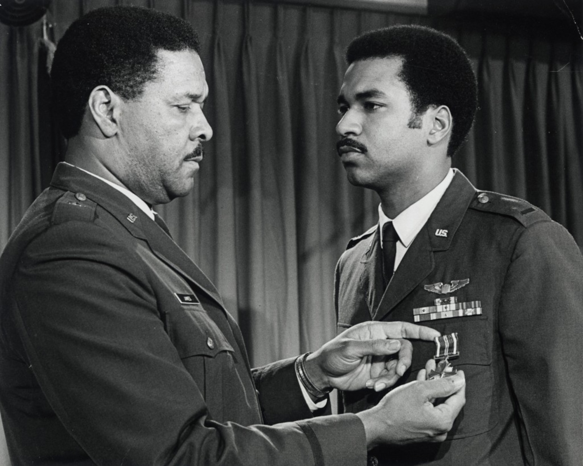Daniel James III receives an award from his father, Gen. Daniel "Chappie" James Jr.  James, who followed in his father's footsteps, served in the Air Force and Air National Guard rising to the rank of Lieutenant General and becoming the first African-American to take command as director of the Air National Guard before retiring in 2006. (U.S. Air Force Photo)