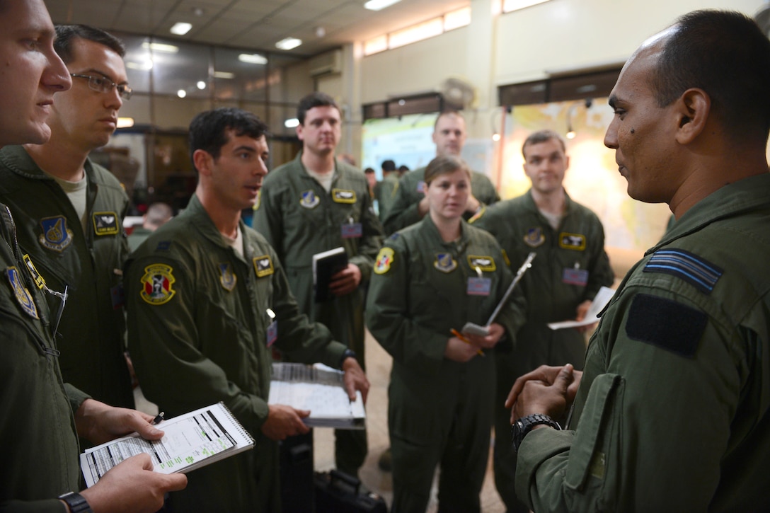 Bangladesh air force squadron leader Rubaiyat, right, meets with U.S. Air Force crew members during exercise Cope South at Bangladesh Air Force Base Bangabandhu, Bangladesh, Jan. 24, 2015. The U.S. crew members are assigned to the 36th Airlift Squadron, Yokota Air Base, Japan.